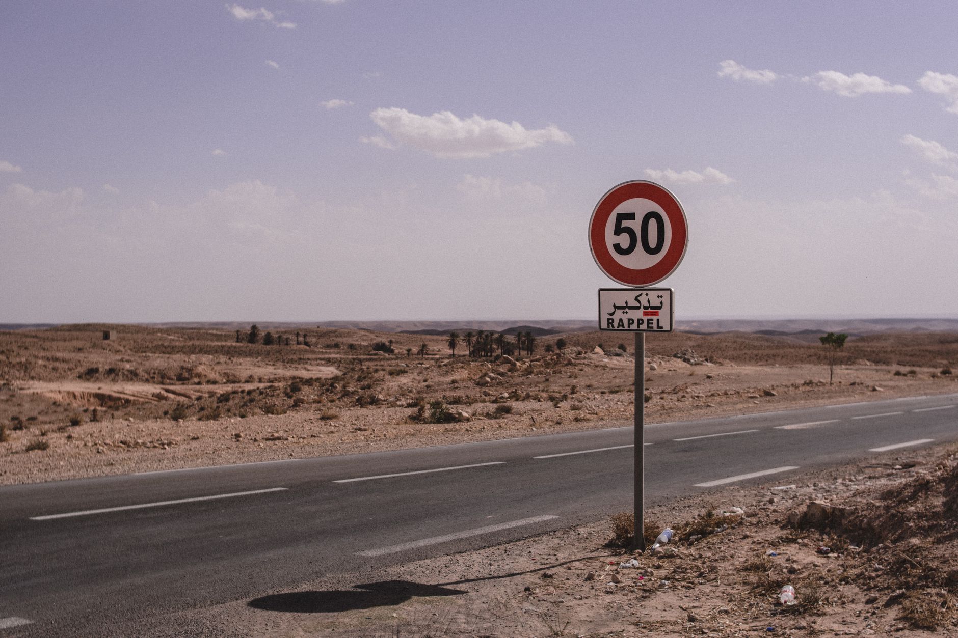 Panneau de limitation de vitesse à 50 km/h avec la mention rappel, au bord d'une route du sud tunisien